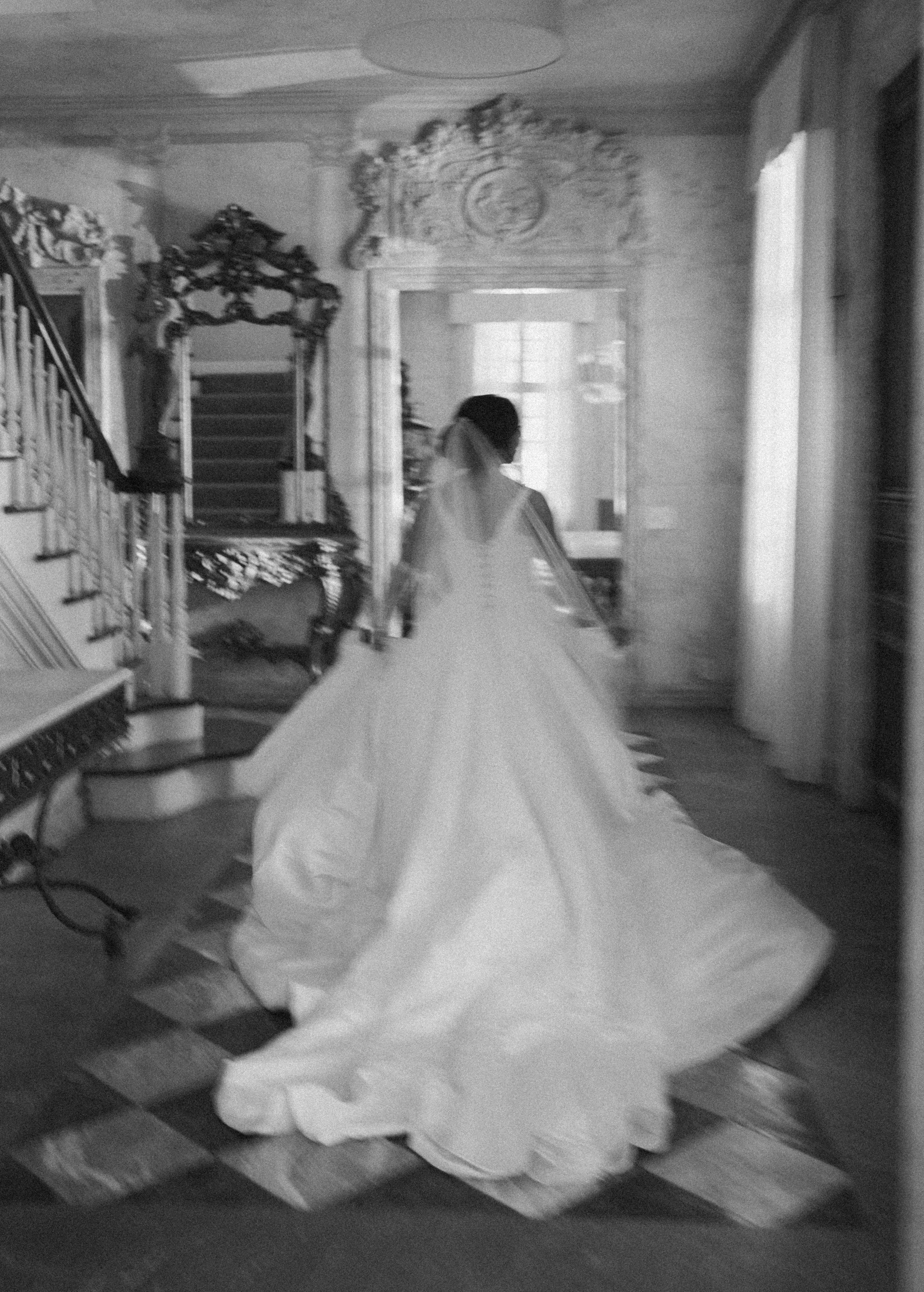Tasia's train sweeping behind her as she walks through La Caille's marble hall, black and white