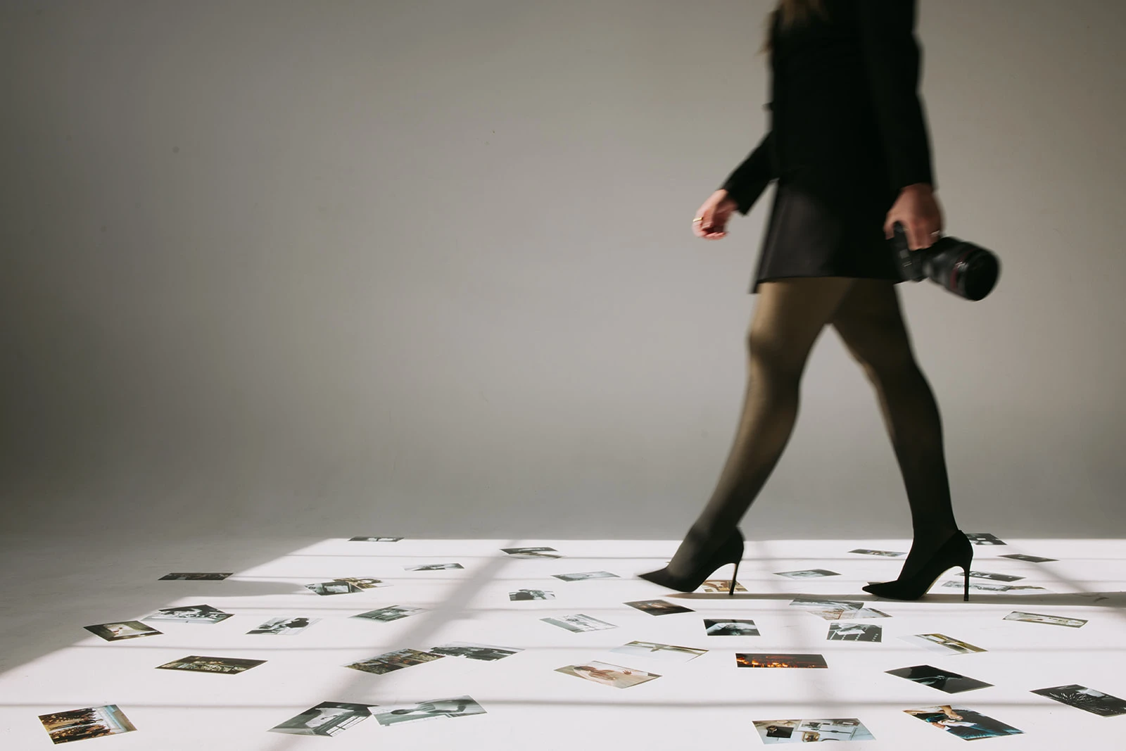 Tiana Simpson walking a photo-strewn studio floor